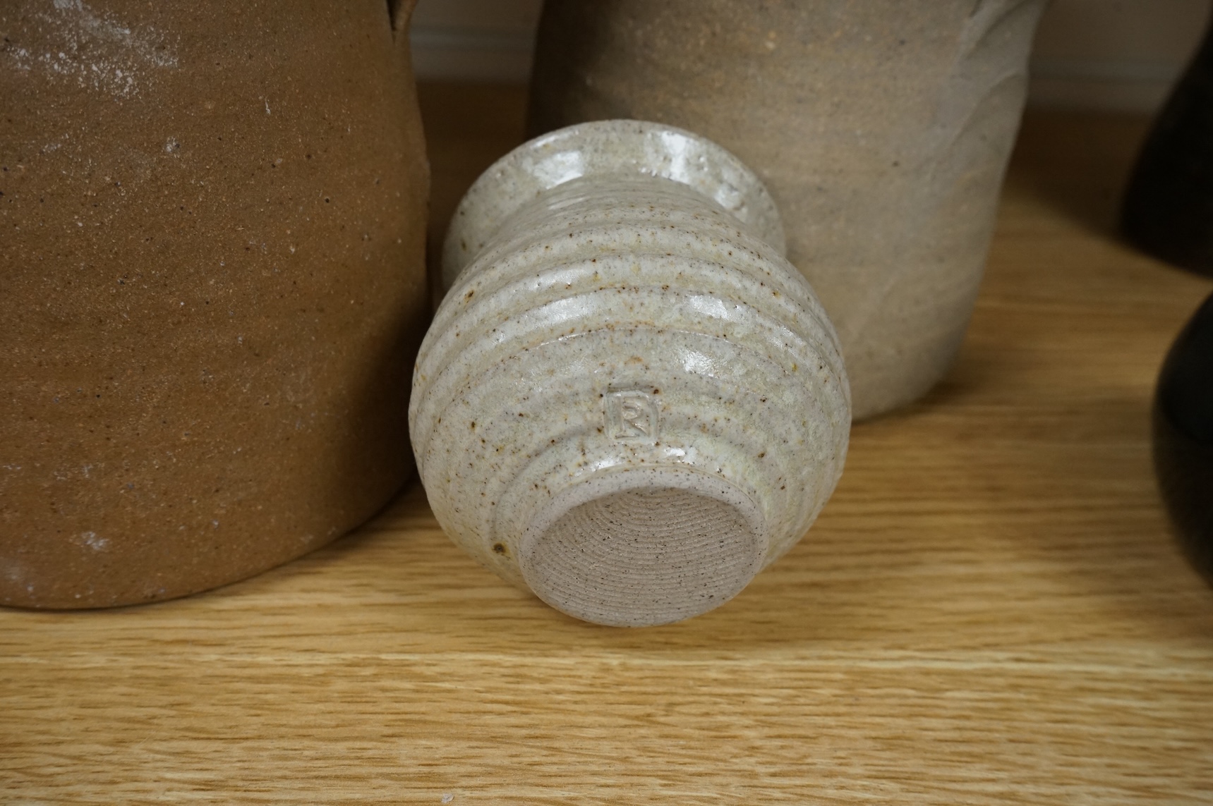 A group of Leach St. Ives pottery jugs and a pot and three other studio items of studio ceramics, some with impressed marks, largest 25cm high